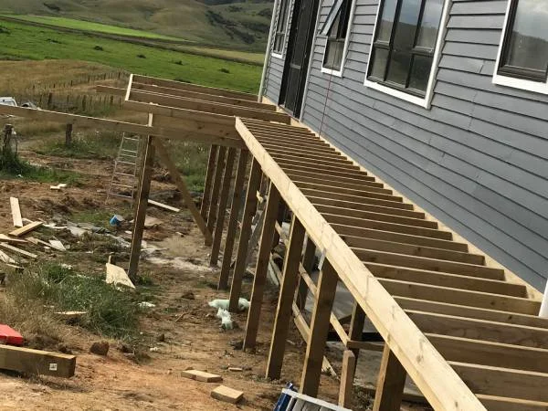 Elevated timber deck frame along house exterior