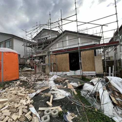 Residential site with bricks and scaffolding under construction